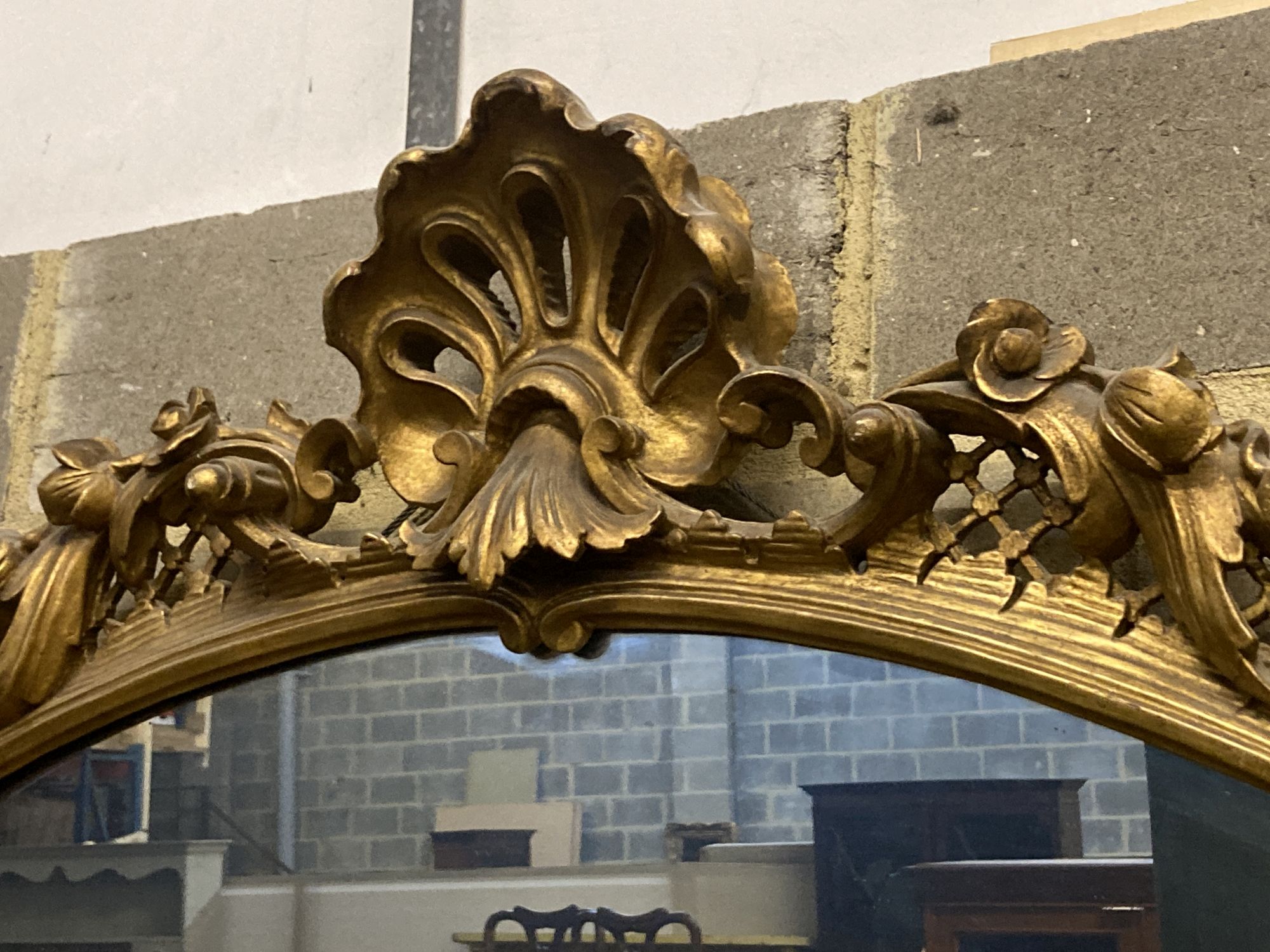 A Victorian ornate gilt oval wall mirror, width 110cm height 100cm